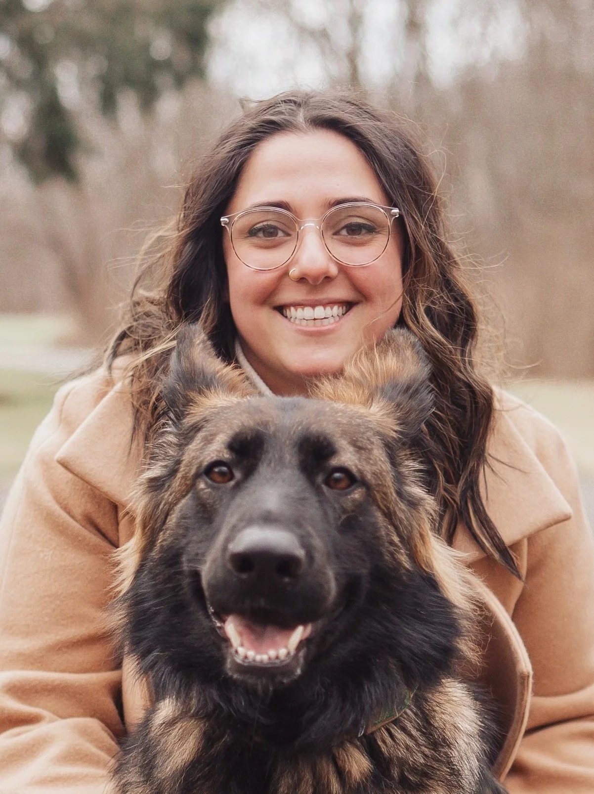 Portrait photo of Emiliya Akopyan with her german shepherd dog Marvel.